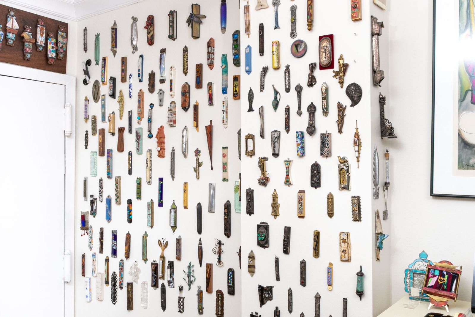 The Rothman mezuzah wall is filled with a collection sourced internationally over decatdes